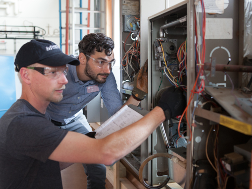 MSTC Student and Instructor working on equipment